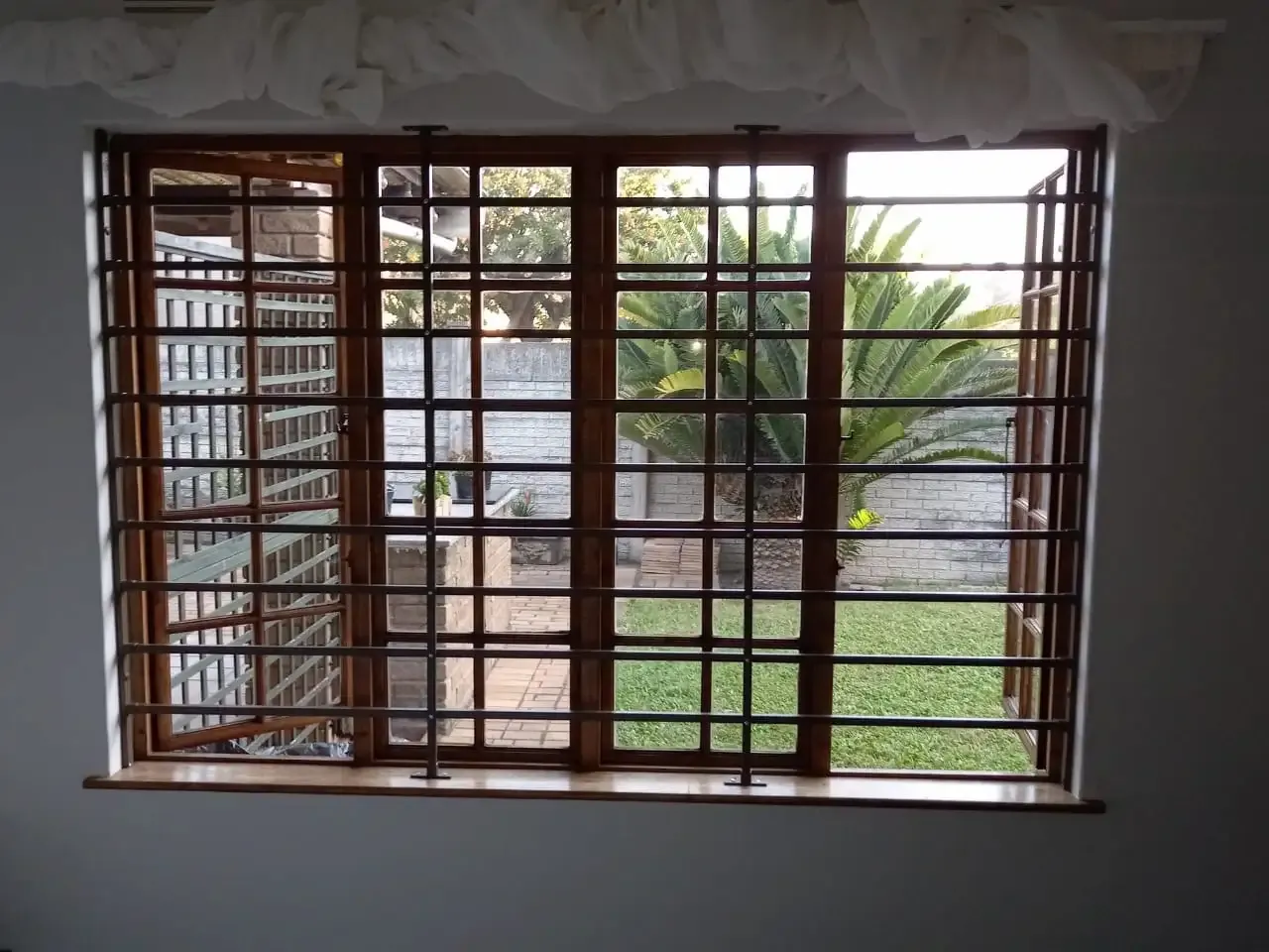 Cottage pane burglar bar installation.