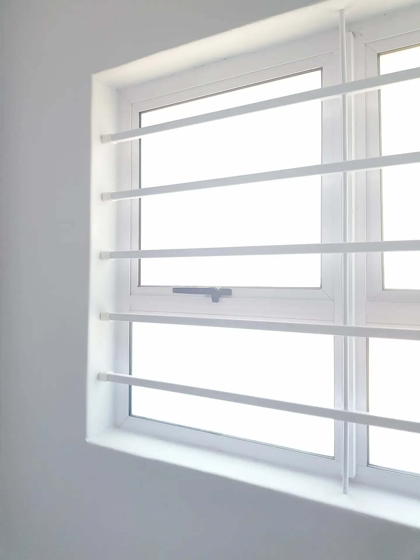 Horizontal steel bars fitted across a window.