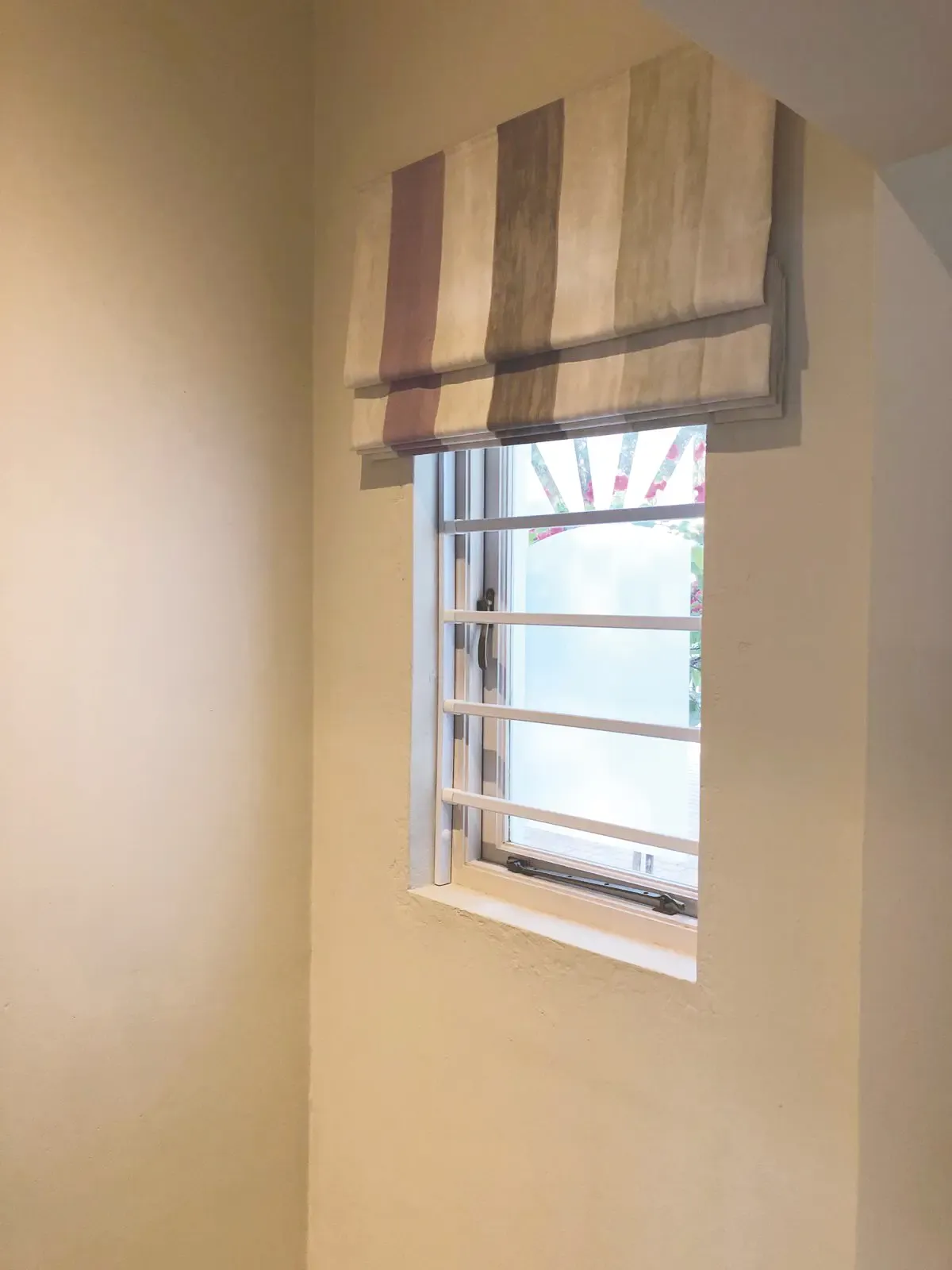 Horizontal steel bars fitted across a window.