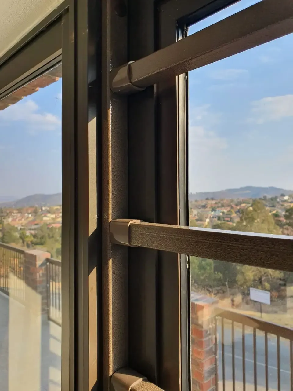 Horizontal steel bars fitted across a window.