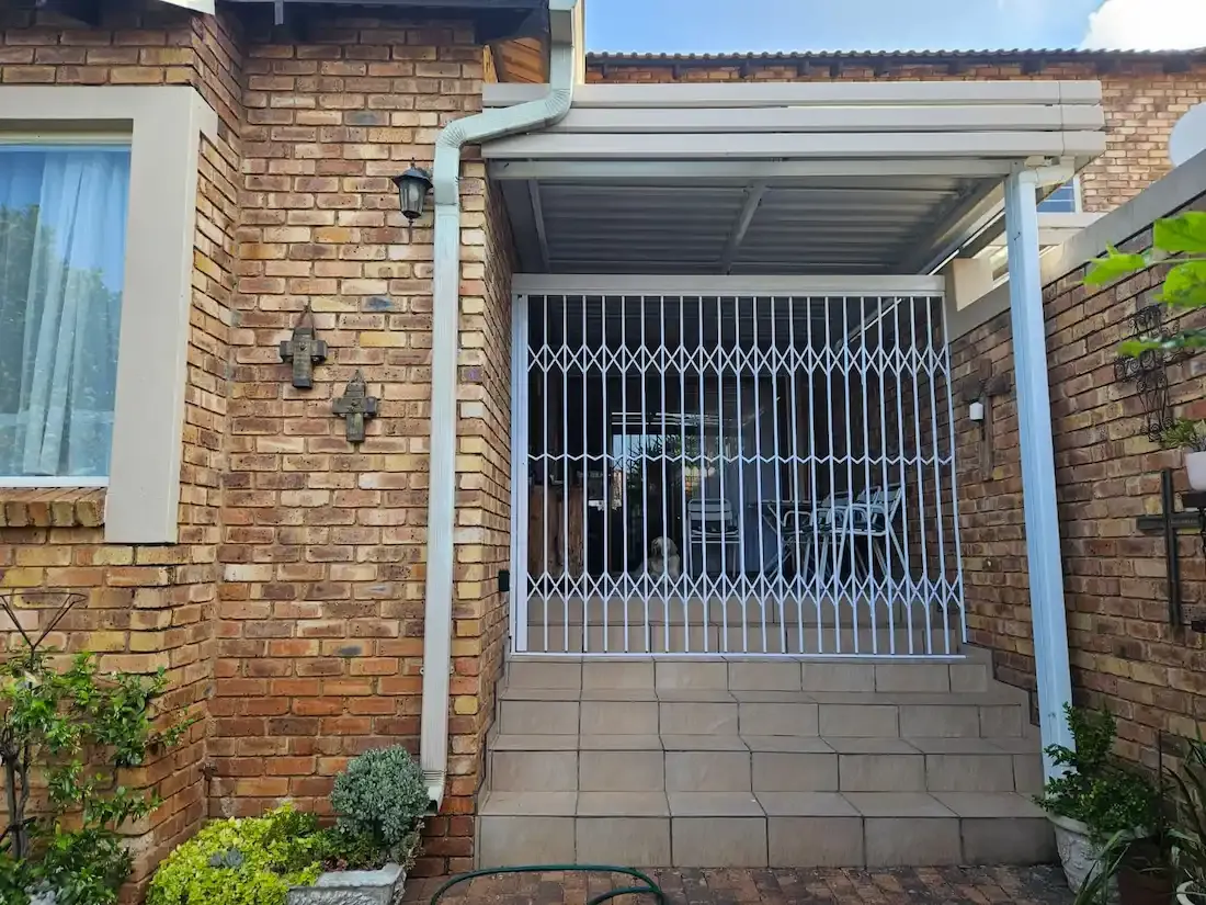Trellis security gate fitted across an opening.