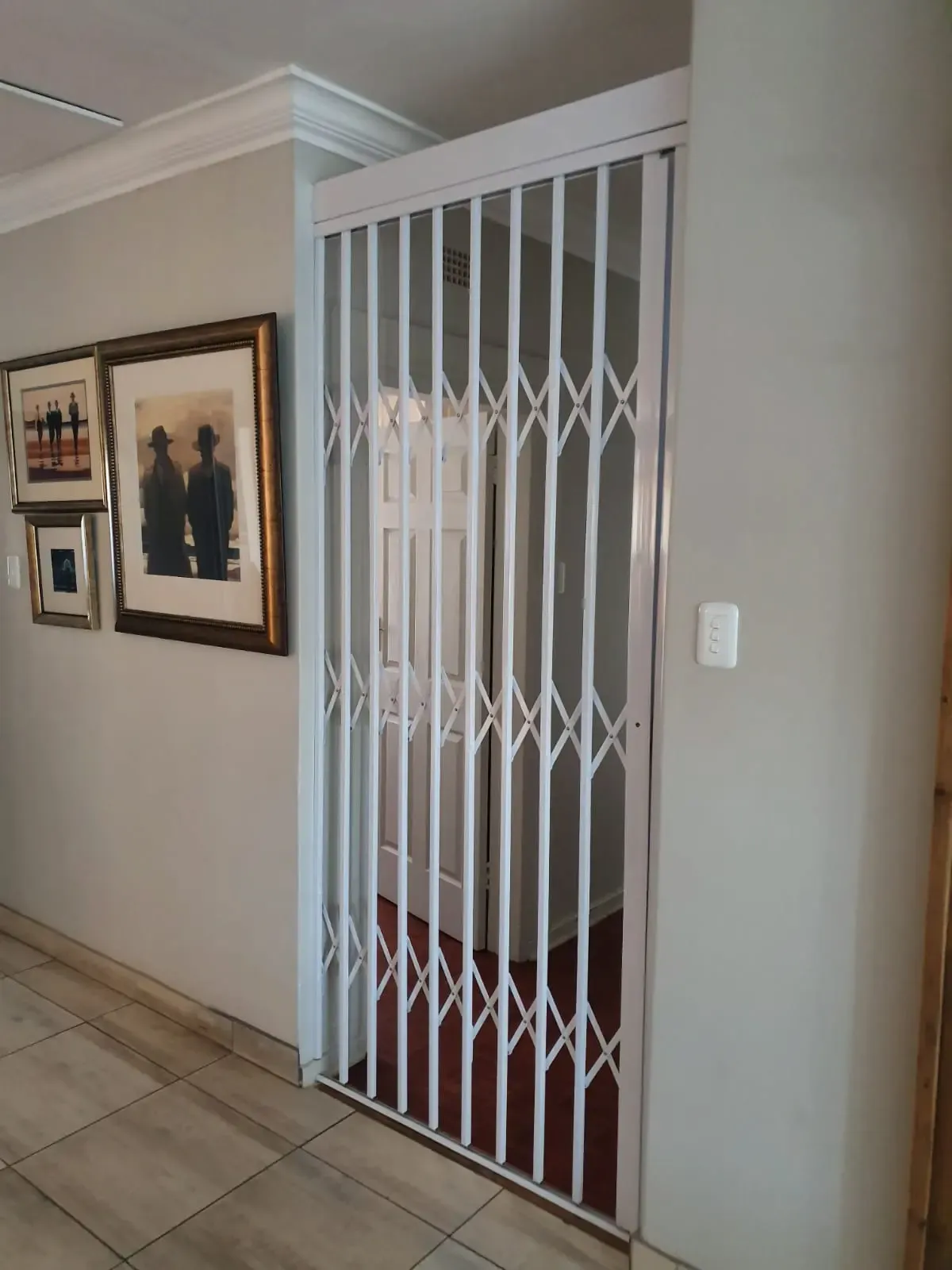 Trellis security gate drawn across a doorway.